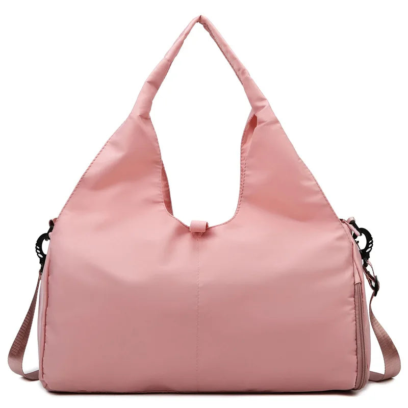 Pink handbag with a shoulder strap on a white background