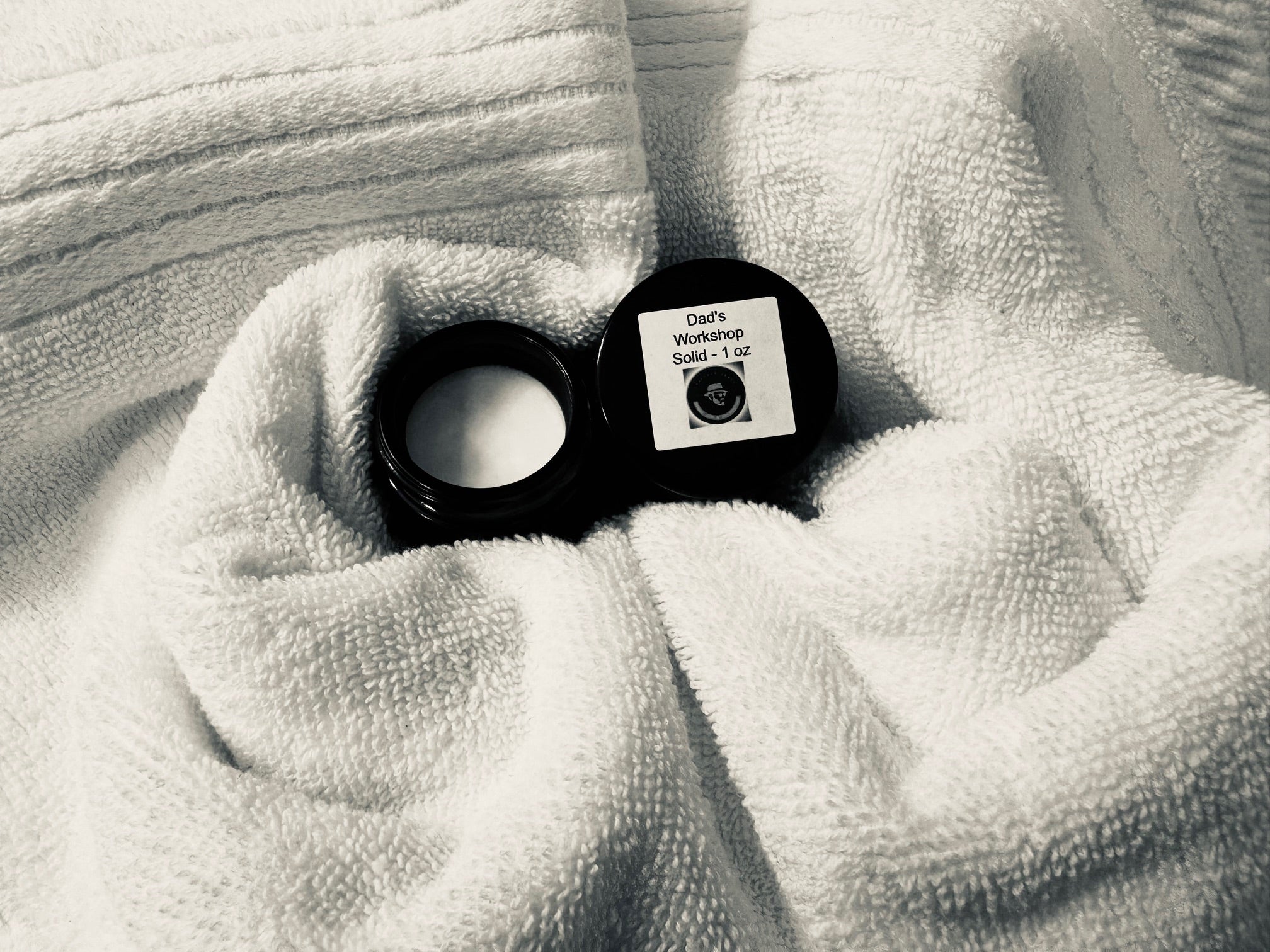 a jar of velvet bloom beauty and wellness balm for men