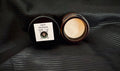Two containers labeled 'Dad's Workshop' on a textured black balm for men at velvet bloom beauty and wellness