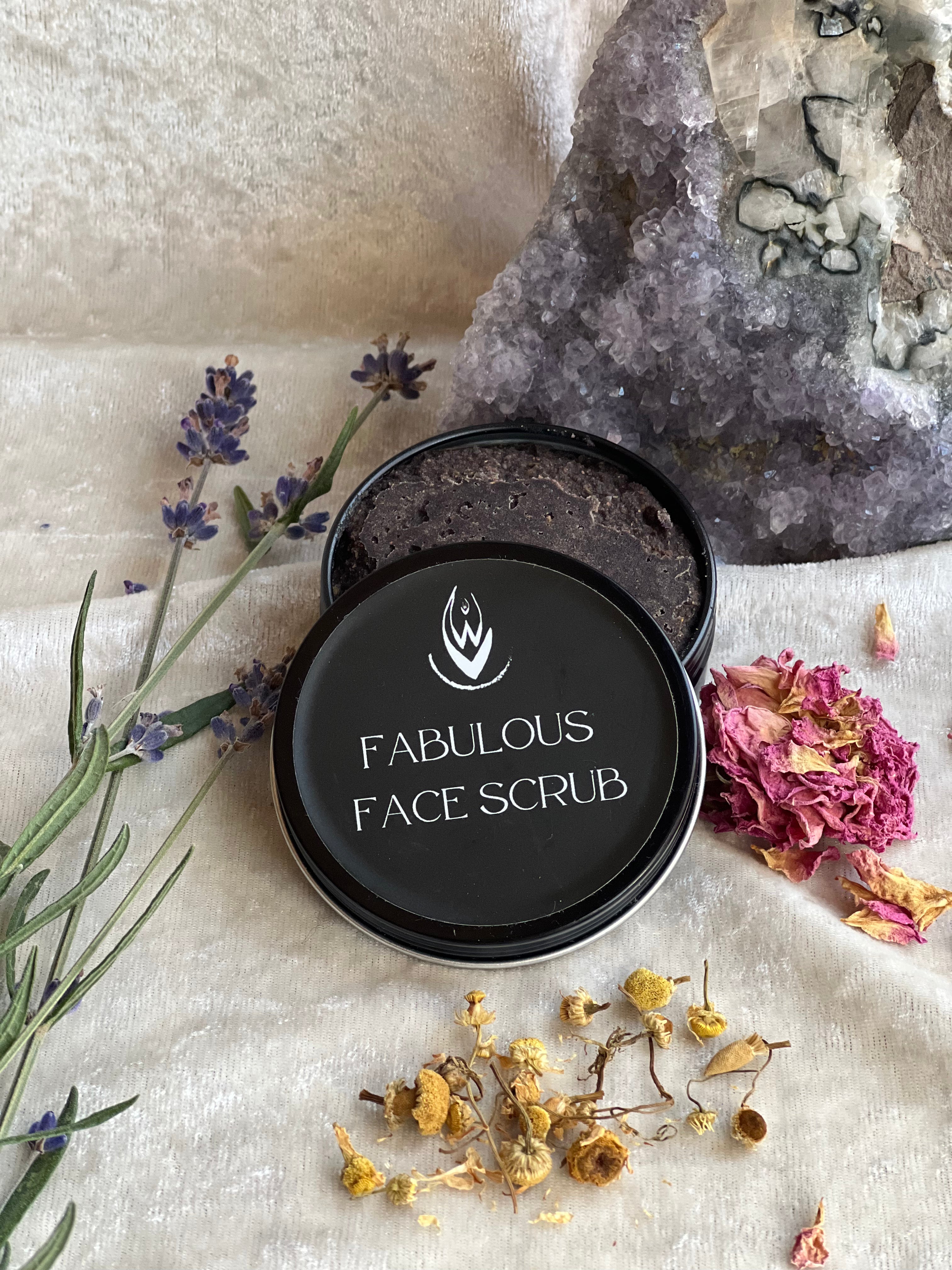 Facial scrub container labeled 'Fabulous Face Scrub' with lavender and flowers on a textured surface.