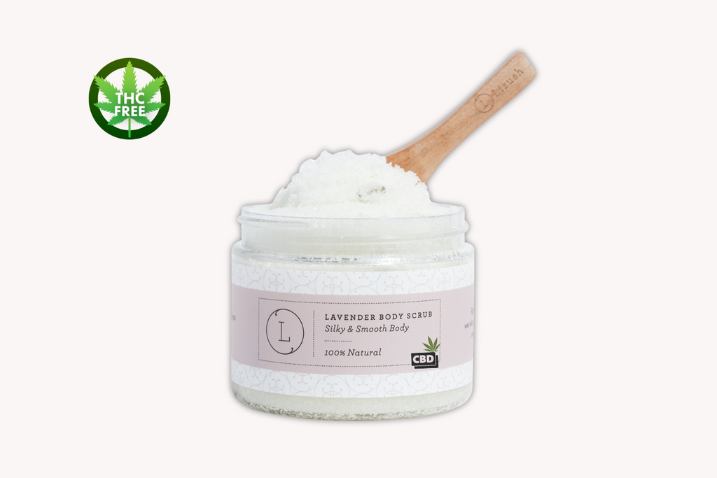 Jar of lavender body scrub with a wooden spoon on a white background. thc free. velvet bloom beauty and wellness