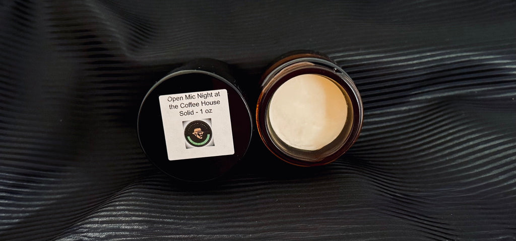 Jar of solid perfume with a label on a black textured background. coffee butter scented