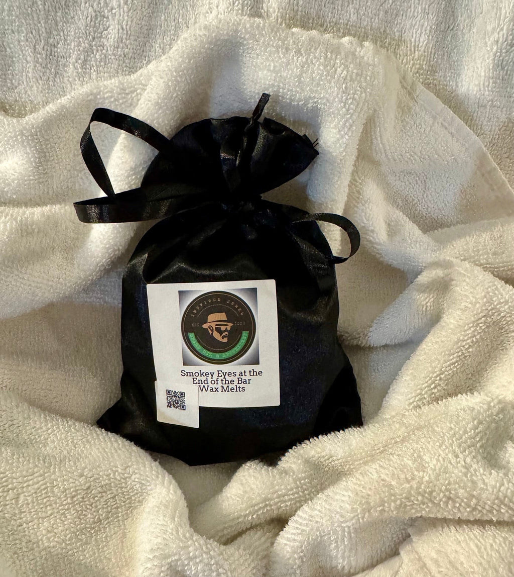 Black drawstring bag with a label on a white textured surface velvet bloom beauty and wellness