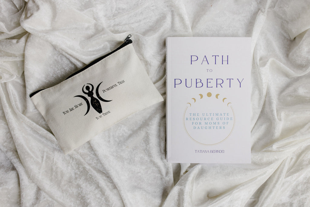 Book titled 'Path to Puberty' and a pouch on a textured white surface