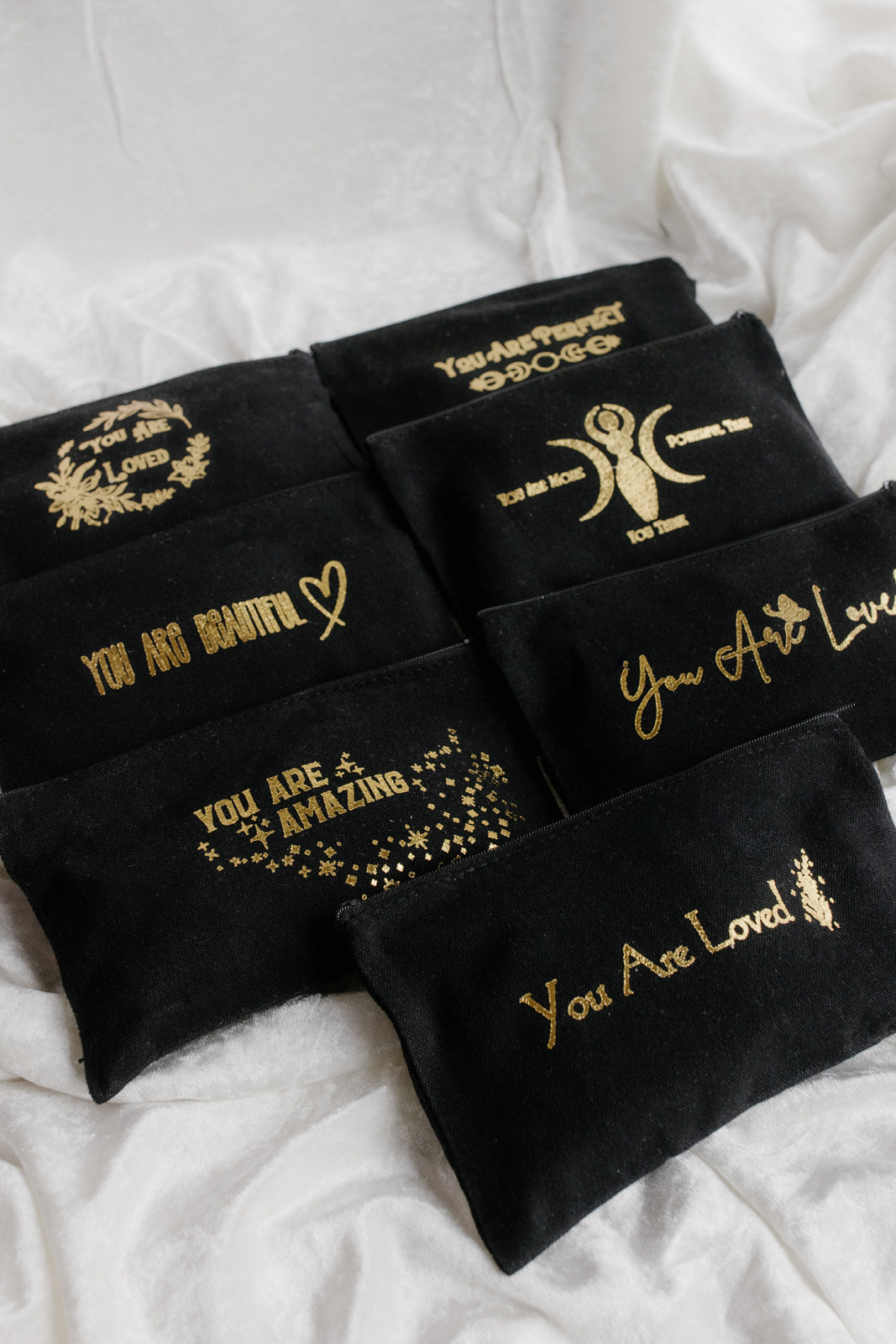 Black headbands with gold text and designs on a white background with affirmation